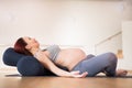 Pregnant woman is engaged in yoga. Reclined Goddess Pose or Supta Baddha Konasana