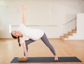 Pregnant woman is engaged in yoga. Revolved side angle pose or Parivrtta Parsvakonasana Royalty Free Stock Photo