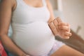 Pregnant woman enjoying of eating chocolate at home. Royalty Free Stock Photo