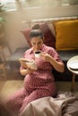 Pregnant woman enjoying at home reading book and holding cup of coffee. Royalty Free Stock Photo