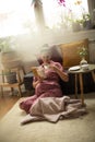 Pregnant woman enjoying at home reading book and holding cup of coffee Royalty Free Stock Photo