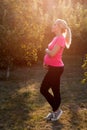Pregnant woman enjoying sunrise at garden