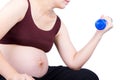 Pregnant woman exercising with dumbbell