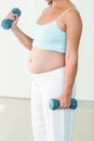 Pregnant woman exercising with dumbbells Royalty Free Stock Photo