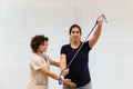 A pregnant woman exercising with an elastic band with help of physiotherapist Royalty Free Stock Photo