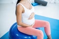 Pregnant woman exercising on exercise ball Royalty Free Stock Photo