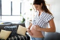 Pregnant woman expecting baby and taking care of skin and stretch marks