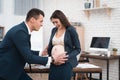 Pregnant woman is experiencing labor in office. Young girl is giving birth in office. Royalty Free Stock Photo