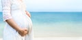 Pregnant woman feeling happy at the beach Royalty Free Stock Photo