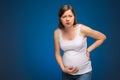 Pregnant woman feeling pain in the back and in the belly, contractions begin. Royalty Free Stock Photo