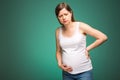 Pregnant woman feeling pain in the back and in the belly, contractions begin. Royalty Free Stock Photo