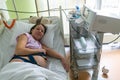 Pregnant woman feels hard contraction in a hospital labor delivery room. Concept photo of pregnancy, pregnant woman