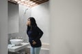 Pregnant woman feels nauseous in the bathroom