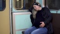 A pregnant woman fell asleep on a subway train. Old subway train car