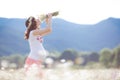 A pregnant woman in a field with a bouquet of white daisies Royalty Free Stock Photo