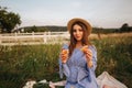 Pregnant woman in the field eating fresh backed crispy croissant. Healthy food. Young woman eats very appetizing