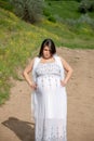 Pregnant woman on the field road Royalty Free Stock Photo