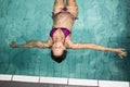 Pregnant woman floating in the pool Royalty Free Stock Photo