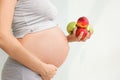 Pregnant woman with fruit in her hands. Vitamins for pregnant women. Vegetarianism. Useful products for pregnant women. Diet