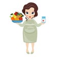 Pregnant woman with a fruit plate in one hand and vitamins bottle in another