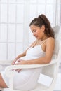 Pregnant woman getting a contraction at home in the living room Royalty Free Stock Photo