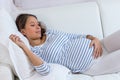 Pregnant woman getting a contraction at home in the living room Royalty Free Stock Photo