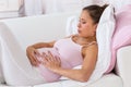 Pregnant woman getting a contraction at home in the living room Royalty Free Stock Photo