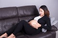 Pregnant woman getting a contraction in the living room Royalty Free Stock Photo