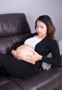 Pregnant woman getting a contraction in the living room Royalty Free Stock Photo