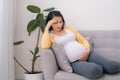 Pregnant woman getting a contraction in the living room at house Royalty Free Stock Photo