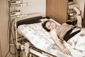 A pregnant woman gives birth in a hospital with a drip and a CTG machine. A woman on a clinic bed during labor pains Royalty Free Stock Photo