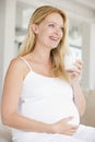 Pregnant woman with glass of milk smiling Royalty Free Stock Photo