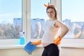 Pregnant woman in gloves with detergent and rag cleaning window Royalty Free Stock Photo