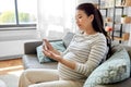 pregnant woman with glucometer making blood test