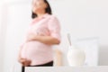 Pregnant woman going to eat healthy natural jogurt Royalty Free Stock Photo