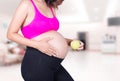 Pregnant woman with green apple in hospital Royalty Free Stock Photo