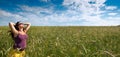 Pregnant woman on green grass field under blue sky Royalty Free Stock Photo