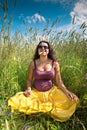 Pregnant woman on green grass field under blue sky Royalty Free Stock Photo