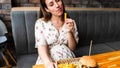 Pregnant woman hamburger eat. Hungry pretty pregnancy female eating tasty burger. Fast food, people and unhealthy eating