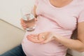 Pregnant Woman Hand With Glass Of Water And Vitamin Pill Royalty Free Stock Photo