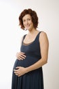 Pregnant woman with hands on belly.