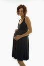 Pregnant woman with hands on belly.