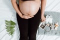 Pregnant woman hands holding on belly making a take care and love symbol on the bedroom with ultrasound image Royalty Free Stock Photo