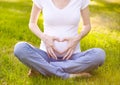 Pregnant woman hands making heart shape on belly Royalty Free Stock Photo