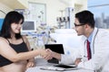 Pregnant woman handshaking with doctor Royalty Free Stock Photo