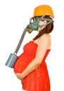 Pregnant woman in hardhat and gas-mask