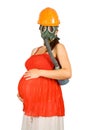 Pregnant woman in hardhat and gas-mask