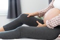 A pregnant woman has leg pain after waking up in the morning. Pregnant women are close to giving birth Royalty Free Stock Photo