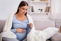 Pregnant Woman Having Fever Measuring Temperature Sitting On Couch Indoor Royalty Free Stock Photo