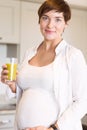 Pregnant woman having a glass of orange juice Royalty Free Stock Photo